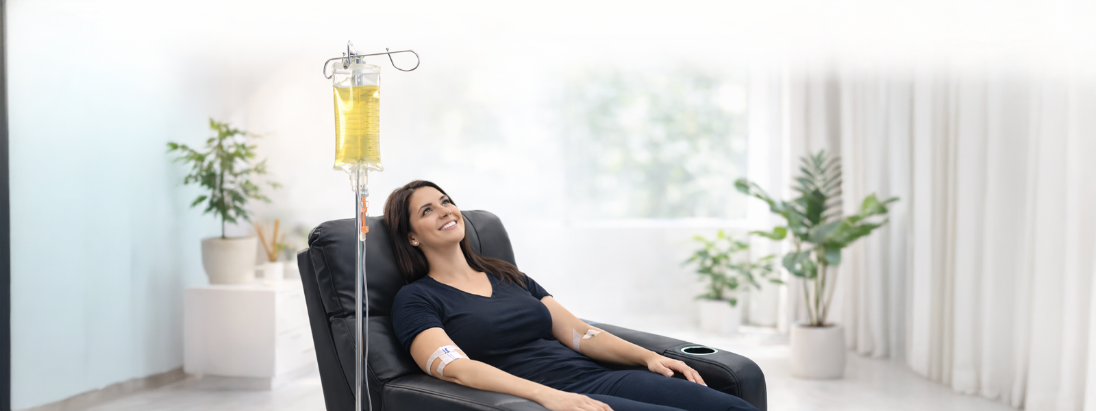 Patient receiving IV hydration therapy in the clinic infusion suite